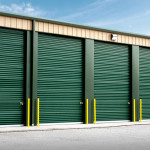 Steel storage units with green garage doors