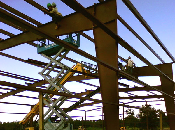 Rhino Steel Building being Constructed with men on scissor lift