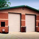 Steel automotive lube shop with brick walls and garage doors