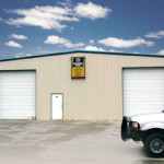 Tan steel auto repair shop with garage doors