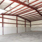 Inside of building with red steel framing and insulation