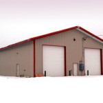 Equipment storage building with garage doors in the snow