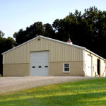 Steel tan ranch shop building with garage door