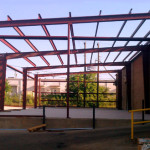 Lean to add on building with red steel framing