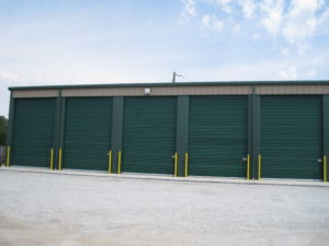 Photo of an attractive self storage facility with attractive forest green storage units.
