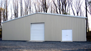 Photo of a large metal storage building with an overhead door.