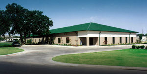 photo of a RHINO commercial building  with a green metal hip roof.