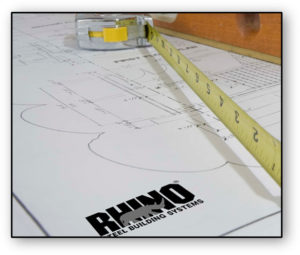 Image of RHINO metal building plans and tape measure.
