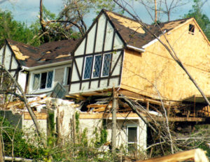 Photo of a badly damage wood house after a severe storm.