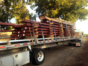 Photo of a steel prefab building kit shipping on a truck.