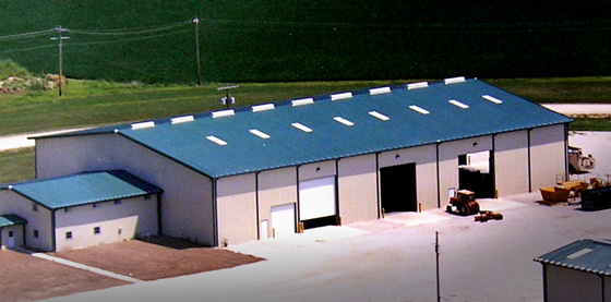 Large industrial metal building with bright blue roofing and trim