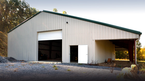 White agricultural metal building with dark green trim