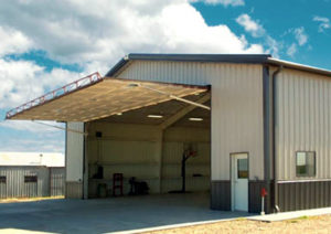 Photo of a RHINO hangar with hydraulic lift door.
