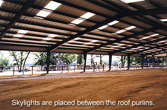 The skylighted roof of  steel riding arena