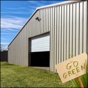 Photo of a large prefab steel building with a sign saying, "Go Green!"