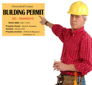 Builder in yellow hard hat points to a metal building permit.