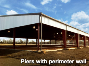 Photo of a riding arena with a pier and perimeter wall foundation.