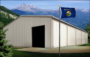 White metal building with light brown trim stands before majestic snow-topped mountains and forests of Montana