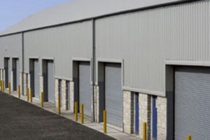 Photo of the receiving doors of a steel warehouse with stone trim.