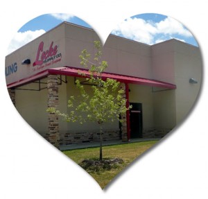 Heart-shaped photo of a stucco-clad steel building used as a plumbing and electrical store