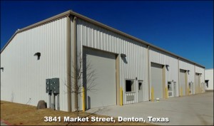 Attractive white industrial steel building with snappy tan trim and four bays