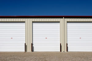 Photo of garage-type steel self storage units with red trim.