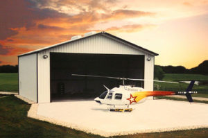 Photo of a RHINO steel hangar with a helicopter.