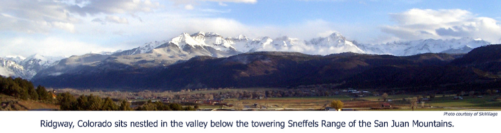 Glorious scenic view of Ridgway, Colorado nestles in a mountain valley beside towering snow-covered peaks