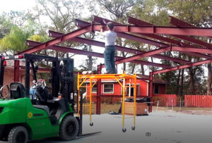 Images shows a man erecting his own RHINO steel building.