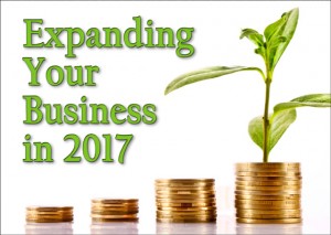 Progressive larger stacks of gold coins beside a healthy green plant and text reading "Expanding Your Business in 2017"