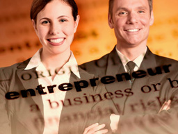 Image of smiling business people with the definition of entrepreneur superimposed over it.