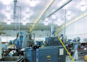 Photo of the interior of an industrial steel building full of large machinery.