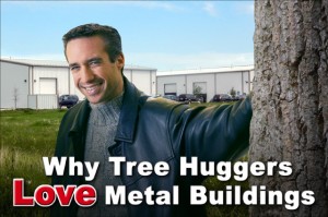 Smiling man in black jacket leans against tree trunk with two white metal buildings in the background 