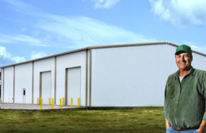 Photo of a large RHINO metal building with two bay doors and a personnel door.