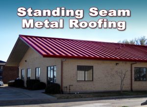 Steel office building with sandy-colored brick and red standing seam metal roof.