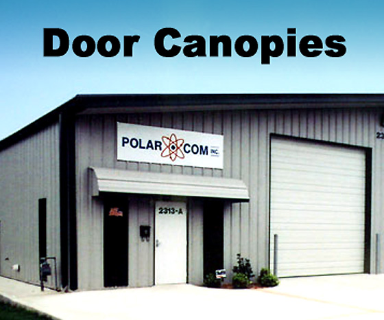 Image shows a canopy over the entry door of a gray metal building with black trim.