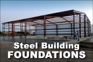 A steel building under construction rests on a slab foundation