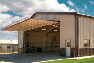 Photo of one of RHINO's airplane hangar kits with the hangar door open.