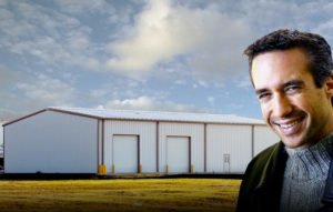 Smiling man with a 40 x 60 metal building behind him.