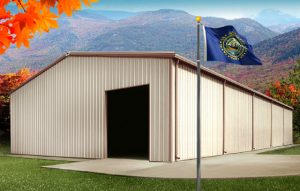 a tan steel building in New Hampshire in autumn, with the state flag flying in front of it