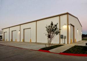 Photo of a 3-bay RHINO pre-engineered building at dusk.