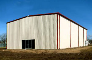 Photo of a tan RHINO steel building with rust-colored trim and gutters.