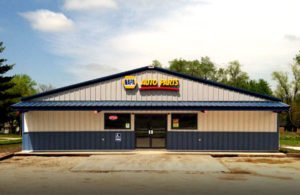 Attractive auto parts store with blue roof and wainscot trim.