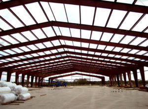 Photo of a industrial steel warehouse under construction.