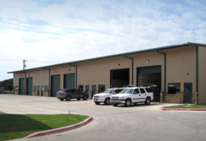 Photo of a six-bay mechanics shop in a RHINO steel garage building.