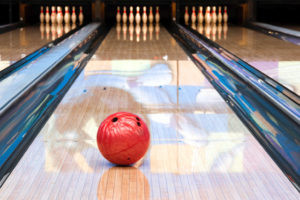 Photo of a ball rolling down a bowling alley.
