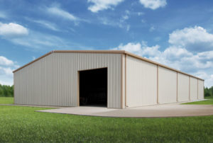 Photo of a large white metal storage building with tan trim and gutters.