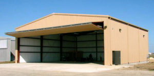 Photo of a bi-fold hangar door on a RHINO steel hangar.
